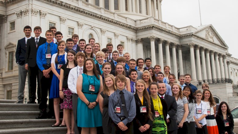 Large Group of Young People Standing In Front of the United States Capitol Building