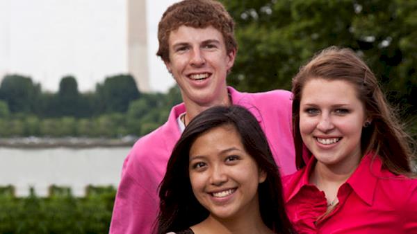 Three Smiling Young People Standing In Front of the Washington Monument