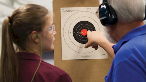 An NRA Instructor Explaining Target Groups to a Young Lady